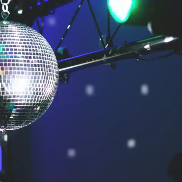 Una bola de discoteca que refleja luces de colores en un espacio oscuro.